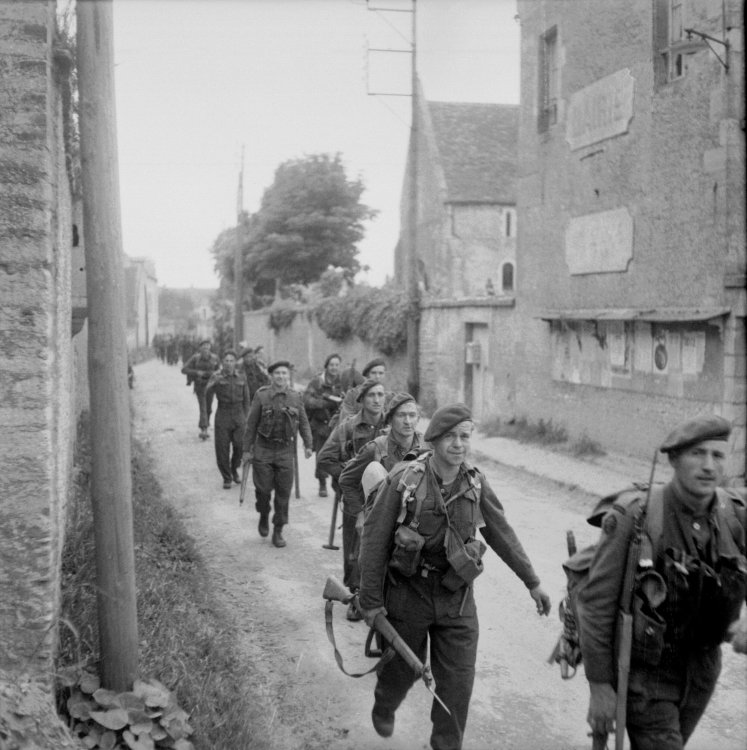 13015370_Royal_Marine_Commandos_attached_to_3rd_Division_for_the_assault_on_Sword_Beach_move_through-_forces_at_Pegasus_Bridge_Normandy_6_June_1944._B5067.thumb.jpg.1fb9901fa3e436f00158b35b8432212b.jpg